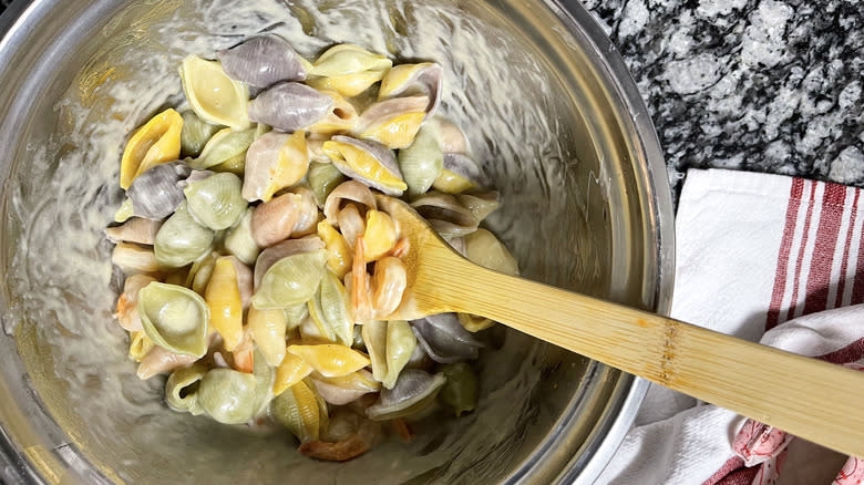 stirring shrimp pasta and sauce