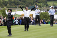 FILE - Europe's Rory McIlroy, left, and Graeme McDowell, second left, react after winning their match on the 17th green as U.S. team members Hunter Mahan, right, and Zach Johnson look on during the third day of the 2010 Ryder Cup golf tournament at the Celtic Manor Resort in Newport, Wales, Sunday, Oct. 3, 2010. The Americans have lost six consecutive Ryder Cups on European soil. (AP Photo/Peter Morrison, File)