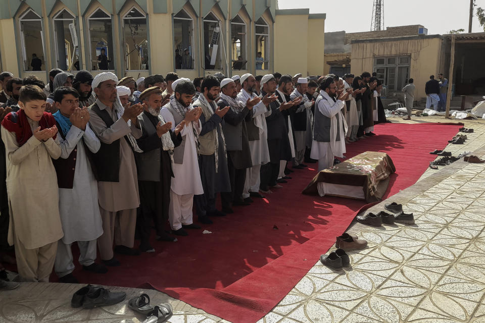 Relatives and residents pray during a funeral ceremony for victims of a suicide attack at the Gozar-e-Sayed Abad Mosque in Kunduz, northern Afghanistan, Saturday, Oct. 9, 2021. The mosque was packed with Shiite Muslim worshippers when an Islamic State suicide bomber attacked during Friday prayers, killing dozens in the latest security challenge to the Taliban as they transition from insurgency to governance. (AP Photo/Abdullah Sahil)