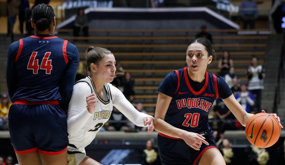 Duquesne Dukes center Ayanna Townsend (44) sets a pick Purdue Boilermakers forward Alaina Harper (32) for Duquesne Dukes guard Amaya Hamilton (20) during the NCAA WNIT basketball game, Thursday, March 28, 2024, at Mackey Arena in West Lafayette, Ind.