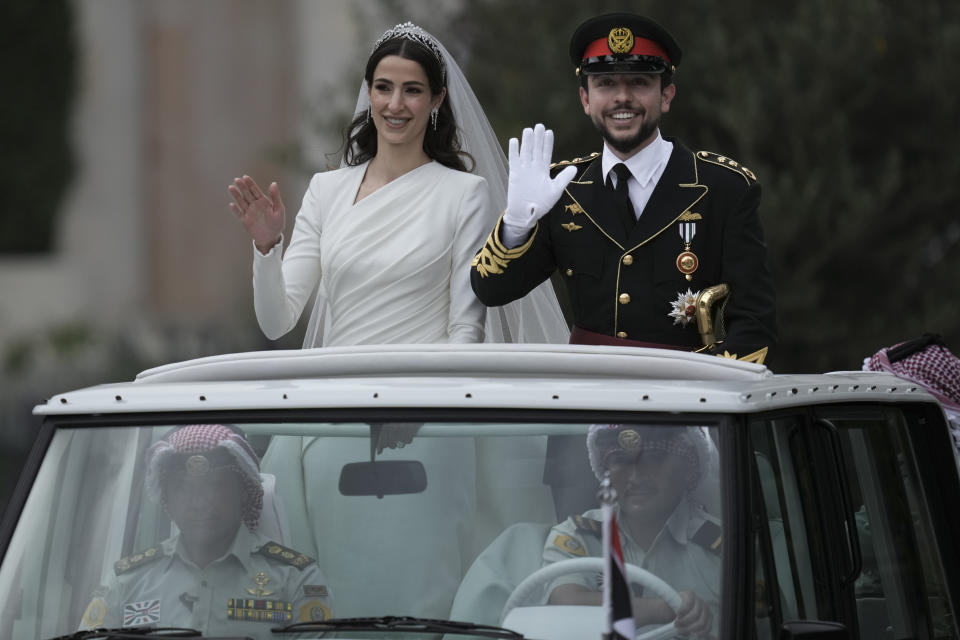 Jordan's Crown Prince Hussein and Saudi Rajwa Alseif wave to well-wishers during their wedding ceremonies in Amman, Jordan, Thursday, June 1, 2023. (AP Photo/Nasser Nasser)