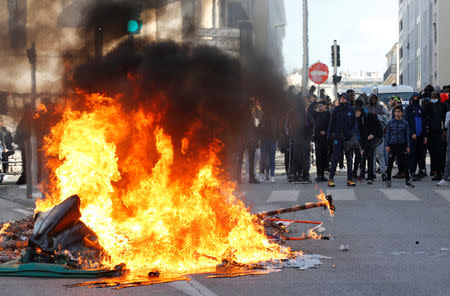 Trash bins burn as youths and high-school students clash with police during a demonstration against the French government's reform plan in Marseille, France, December 6, 2018. REUTERS/Jean-Paul Pelissier