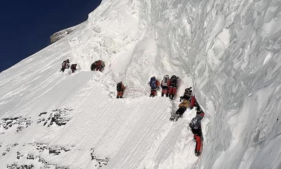 Mohammed Hassan, seen lying prone on the ground, had fallen from a sheer ledge (Lakpa Sherpa (8k Expeditions))