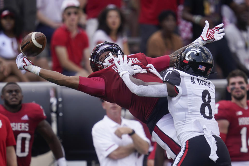 Indiana's Reese Taylor (2) tries to intercept a pass intended for Cincinnati's Michael Young Jr. (8) during the second half of an NCAA college football game, Saturday, Sept. 18, 2021, in Bloomington, Ind. Cincinnati won 38-24. (AP Photo/Darron Cummings)