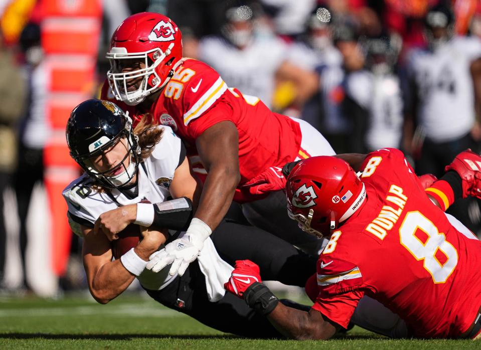 Chiefs defensive tackle Chris Jones (95) and Carlos Dunlap (8) combine on a sack of Jaguars quarterback Trevor Lawrence on Nov. 13, when Kansas City won 27-17.
