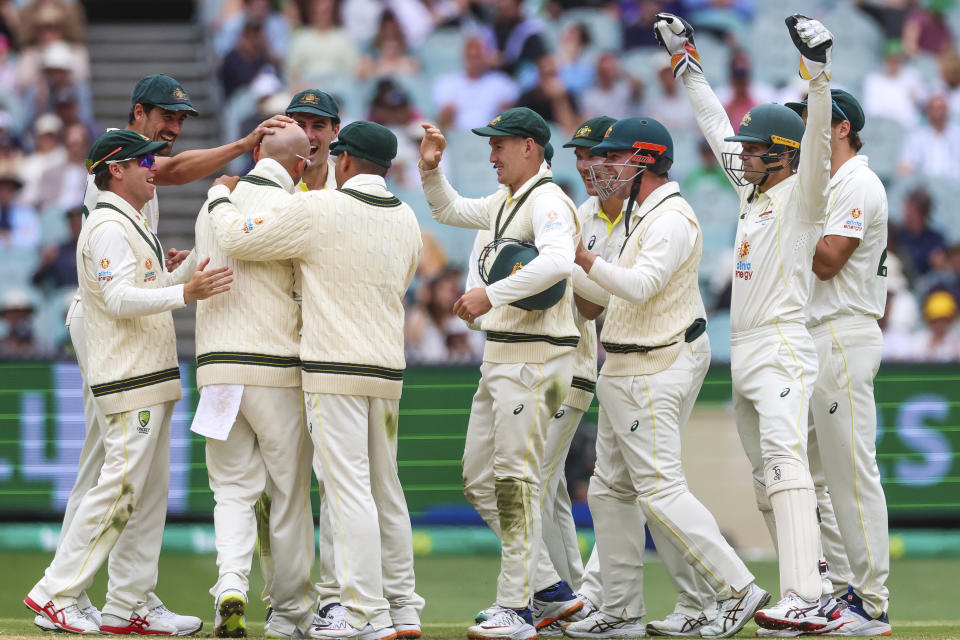 Australian players celebrate after Australia's Nathan Lyon gets the wicket of South Africa's Marco Jansen during the second cricket test between South Africa and Australia at the Melbourne Cricket Ground, Australia, Thursday, Dec. 29, 2022. (AP Photo/Asanka Brendon Ratnayake)