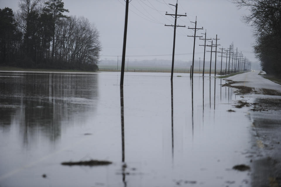 A section of Mooresville Road, between Humphrey Road and Old Hwy 20 is partially flooded and closed to traffic on Friday, Feb. 22, 2019, in Decatur, Ala. (Jeronimo Nisa/The Decatur Daily via AP)