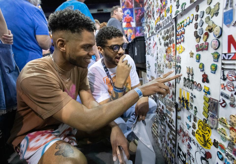 Elijah Williams, left, and Thailan Westley shop for pins during PensaCon at the Bay Center in Pensacola on Friday, Feb. 24, 2023.