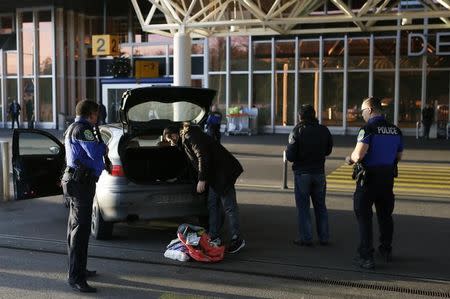 County of Geneva police officers check a car outside Cointrin airport in Geneva, Switzerland, December 10, 2015. REUTERS/Pierre Albouy