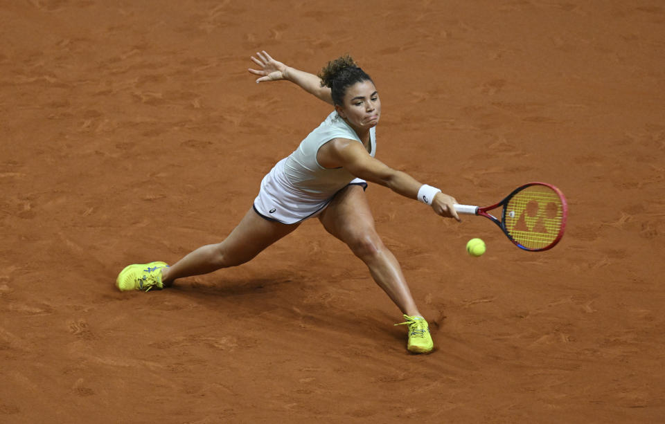 Italy's Jasmine Paolini returns a shot during her quarterfinals tennis match against Kazakhstan's Elena Rybakina at the WTA Tour in Stuttgart, Germany, Friday April 19, 2024. (Marijan Murat/dpa via AP)