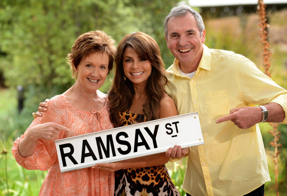 SYDNEY, AUSTRALIA - MARCH 17: (EUROPE AND AUSTRALASIA OUT) Paula Abdul (C) poses with actors Jackie Woodburne and Alan Fletcher on the set of Australian television soap opera 'Neighbours', where she will appear in a cameo role, on March 17, 2014 in Melbourne, Australia. (Photo by Kylie Else/Newspix/Getty Images)