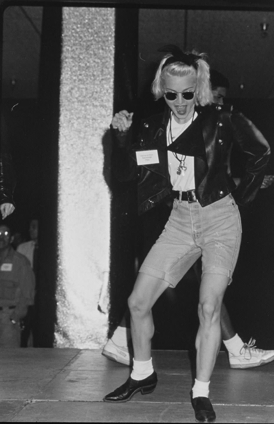 <p>Madonna paired the flat shoes with ankle socks, Bermuda shorts, and a leather jacket during a dance-a-thon. </p>