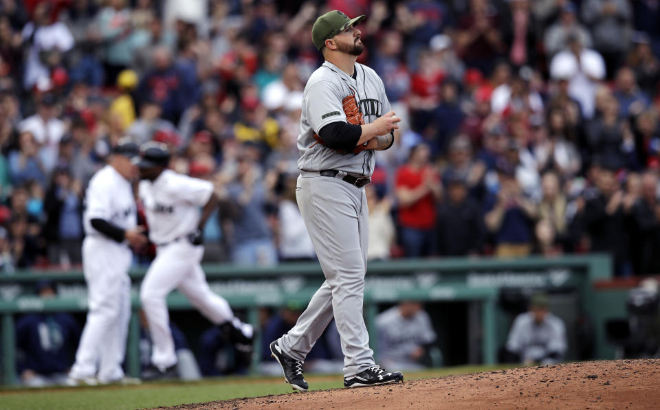 Seattle Mariners starting pitcher Rob Whalen prepares a fresh baseball as he walks back to the mound while Boston Red Sox's Jackie Bradley Jr. rounds the bases on his two-run home run during the sixth inning of a baseball game at Fenway Park in Boston, Saturday, May 27, 2017. (AP Photo/Charles Krupa)