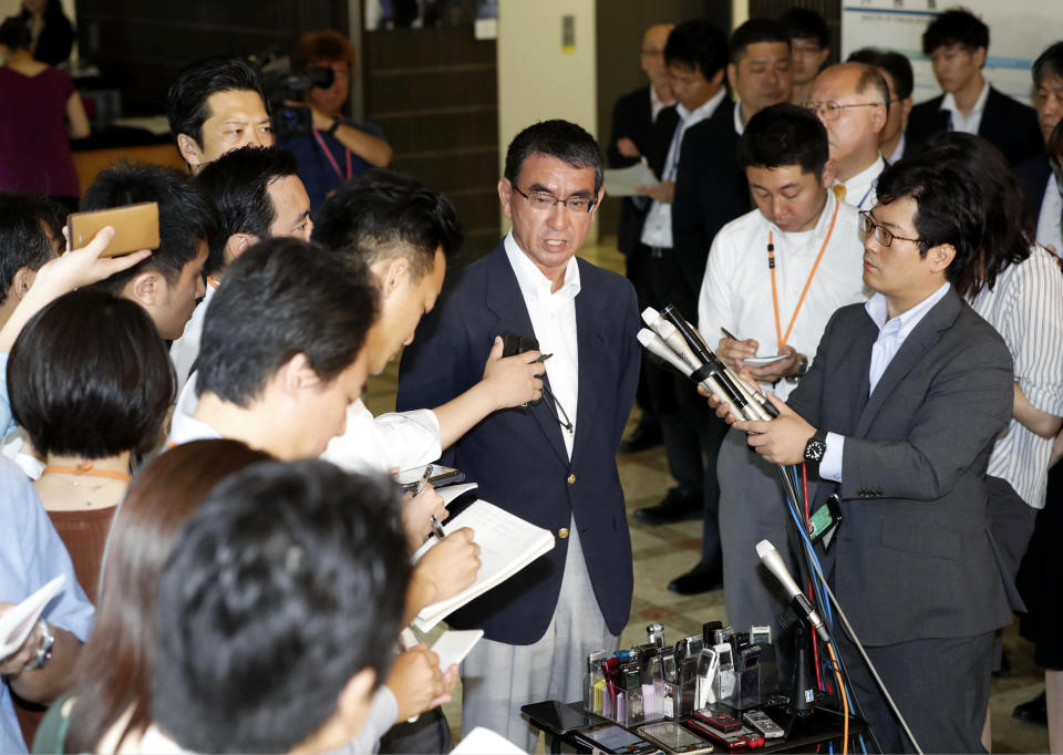 Japan's Foreign Minister Taro Kono, center, speaks to the media after meeting with South Korean Ambassador to Japan Nam Gwan Pyo, at foreign ministry in Tokyo Friday, July 19, 2019. Japan has summoned South Korea's ambassador to protest Seoul's refusal to join in an arbitration panel to settle a dispute over World War II labor. (Masanobu Kumagai/Kyodo News via AP)