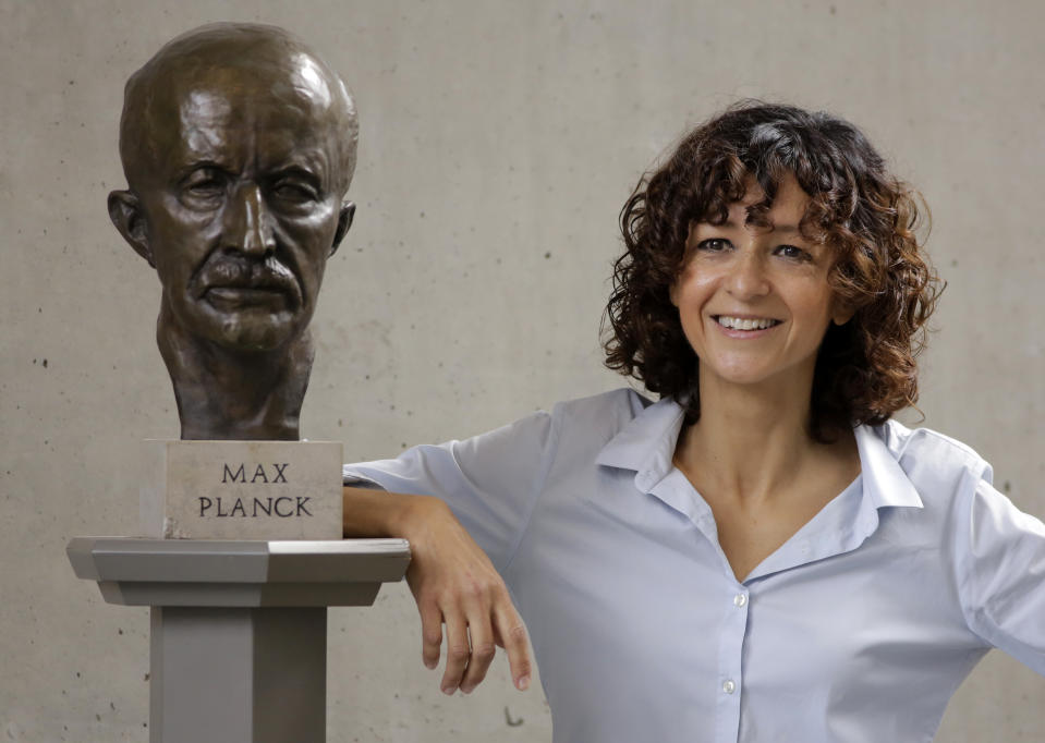 French microbiologist Emmanuelle Charpentier poses near a statue of Max Planck in Berlin, Germany, Wednesday, Oct. 7, 2020. French scientist Emmanuelle Charpentier and American Jennifer A. Doudna have won the Nobel Prize 2020 in chemistry for developing a method of genome editing likened to 'molecular scissors' that offer the promise of one day curing genetic diseases. (AP Photo/Markus Schreiber)