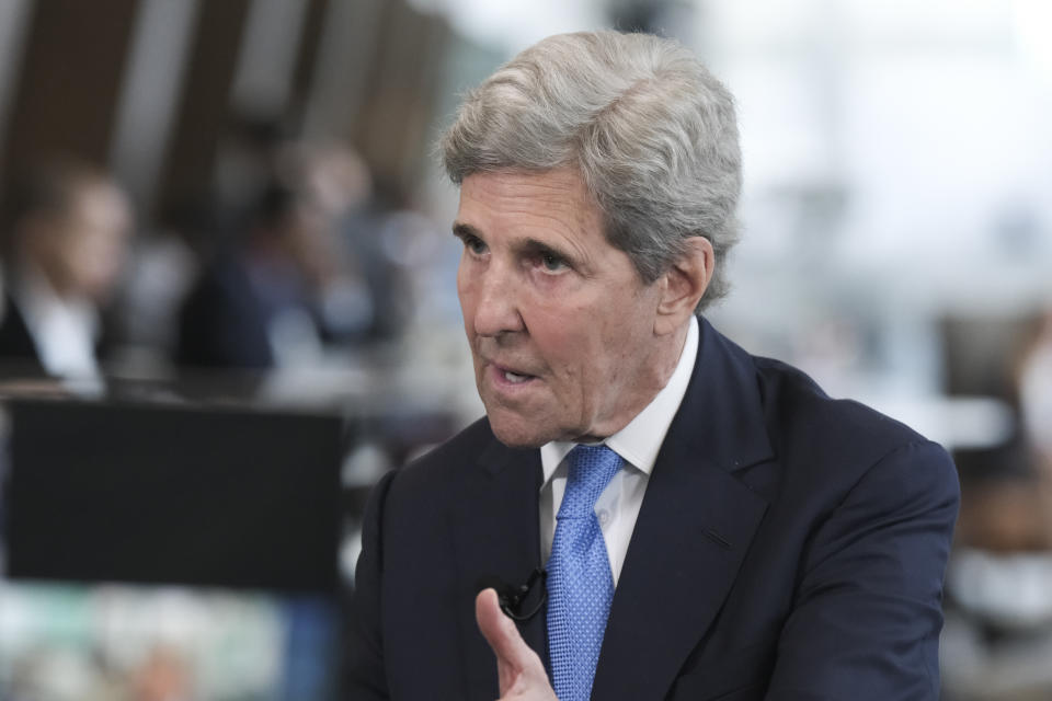 John Kerry involved in a discussion.