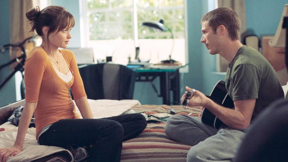 Girl and guy sitting on a bed