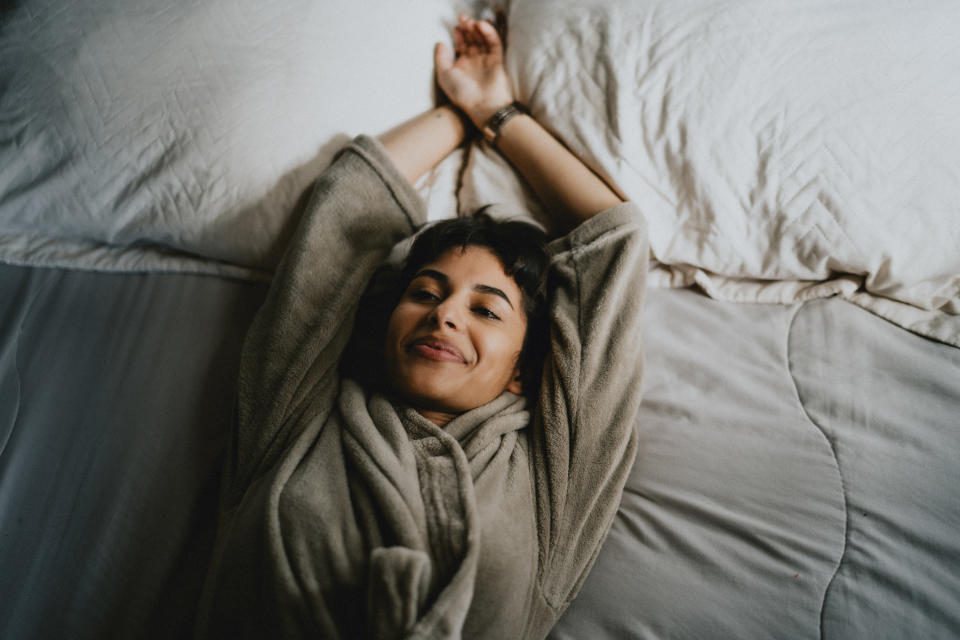 Young woman resting on a bed