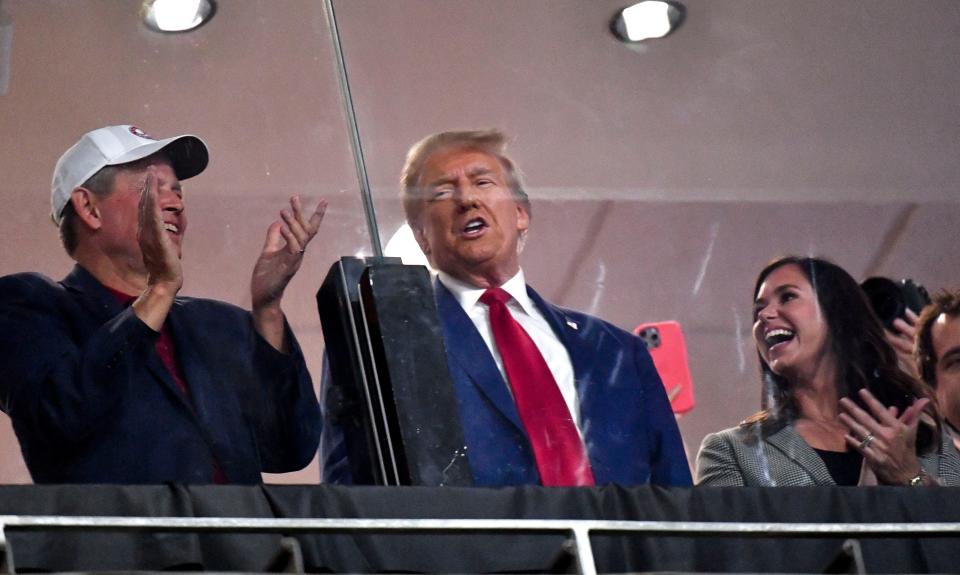 Sep 28, 2024; Tuscaloosa, Alabama, USA; Former president and current Republican nominee for president Donald J. Trump visits Bryant-Denny Stadium for the football game between Alabama and Georgia. Trump stands with Senator Katie Britt, Republican from Alabama. Mandatory Credit: Gary Cosby Jr.-Imagn Images