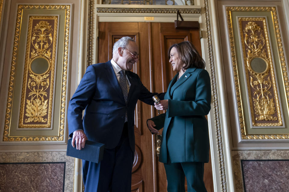 Senate Majority Leader Sen. Chuck Schumer, D-N.Y., presents Vice President Kamala Harris with a golden gavel after she cast the 32nd tie-breaking vote in the Senate, the most ever cast by a vice president, Tuesday, Dec. 5, 2023, on Capitol Hill in Washington. (AP Photo/Stephanie Scarbrough)