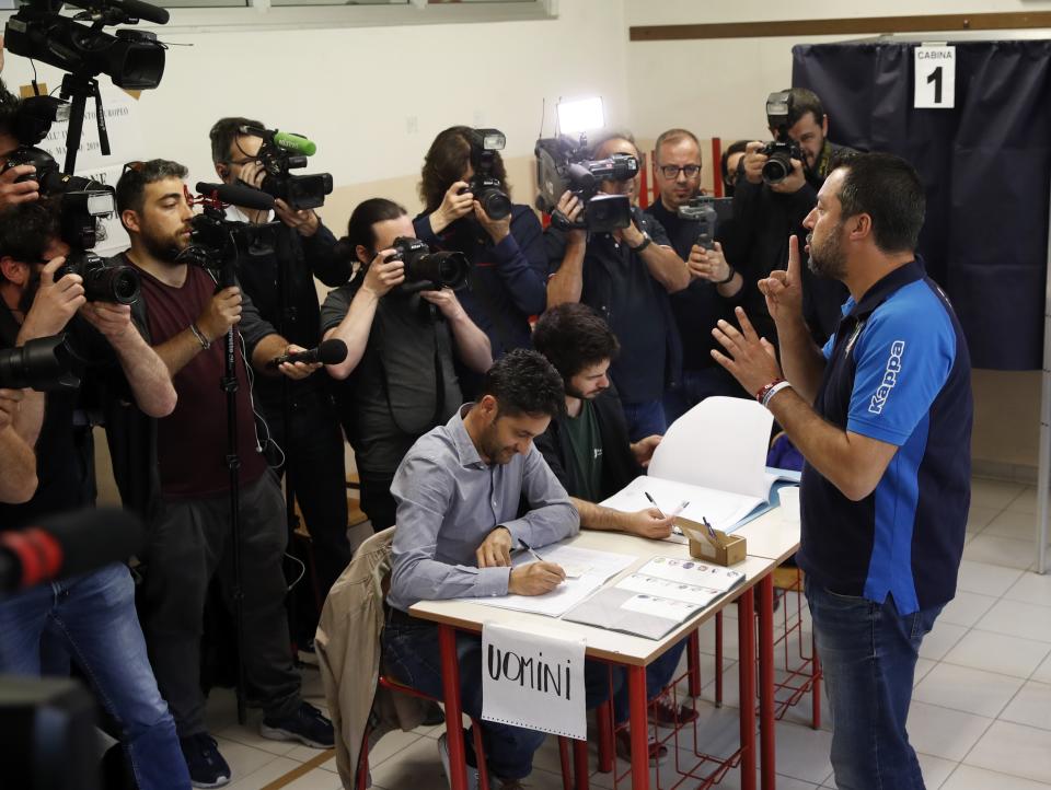 Italian Interior Minister and Deputy Premier Matteo Salvini, of the League, gestures to photographers and cameramen to keep quiet as he arrives to vote for the European Parliament elections at a polling station in Milan, Italy, Sunday, May 26, 2019. Pivotal elections for the European Union parliament reach their climax Sunday as the last 21 nations go to the polls and results are announced in a vote that boils down to a continent-wide battle between euroskeptic populists and proponents of closer EU unity. (AP Photo/Antonio Calanni)
