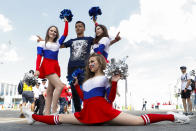 <p>Cheerleaders pose for photos with a soccer fan outside the Nizhny Novgorod Stadium </p>