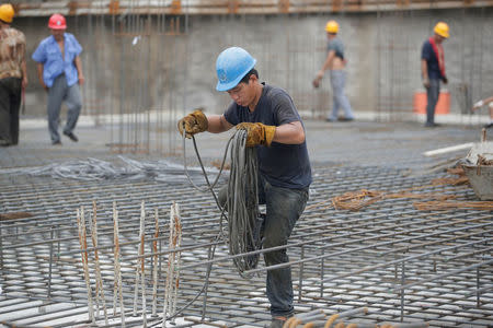 Yu Jinting, 26, from Baoding in Hebei province, works at a construction site in Beijing, China July 20, 2017. REUTERS/Jason Lee