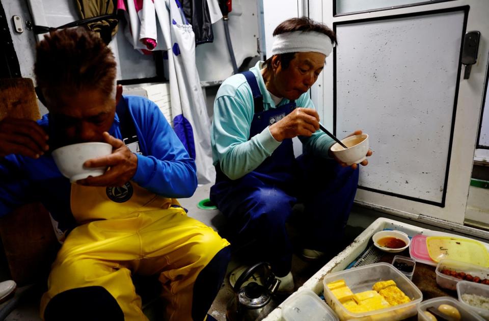 Takeo Nakajo, captain of the Nakajomaru katsuo, eats breakfast with his crew before work (Reuters)