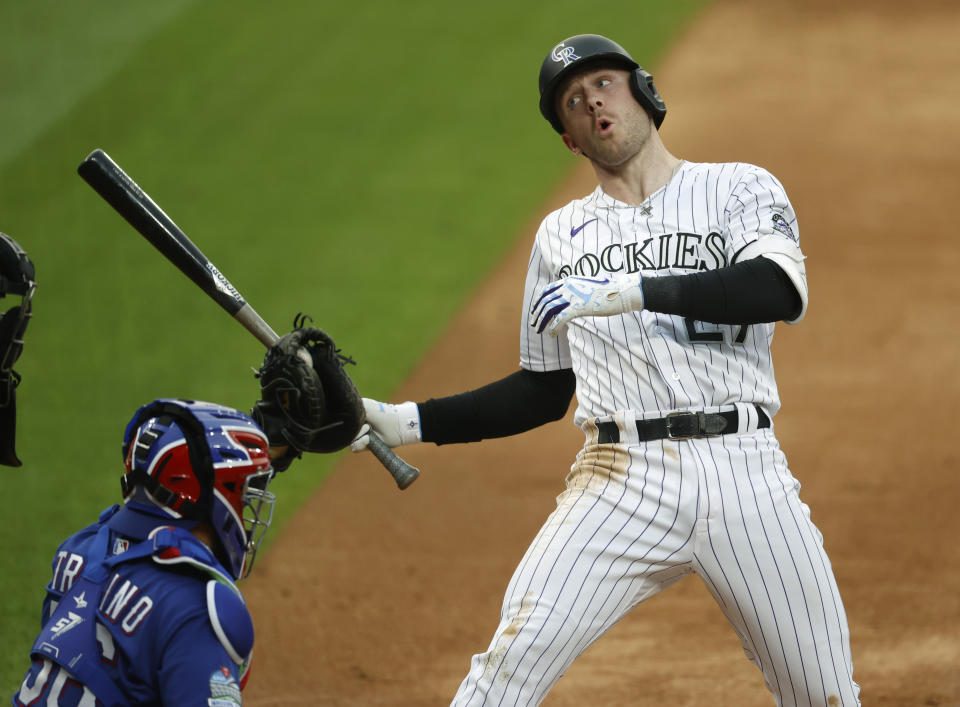 FILE - Colorado Rockies' Trevor Story, right, reacts to a high, inside pitch from Texas Rangers starting pitcher Kyle Gibson as catcher Jose Trevino pulls in the ball in the third inning of a baseball game in this file photograph taken Saturday, Aug. 15, 2020, in Denver. Story, who will be a free agent at the end of the 2021 campaign, has become the face of the Rockies with the trade of third baseman Nolan Arenado to St. Louis. (AP Photo/David Zalubowski, File)