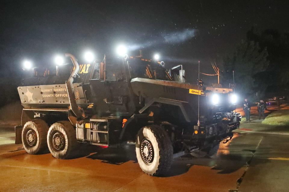 The Summit County Sheriff's SWAT Team blocks the intersection of Bellows and Crosier streets Tuesday night after protests outside the Summit County Jail in Akron.