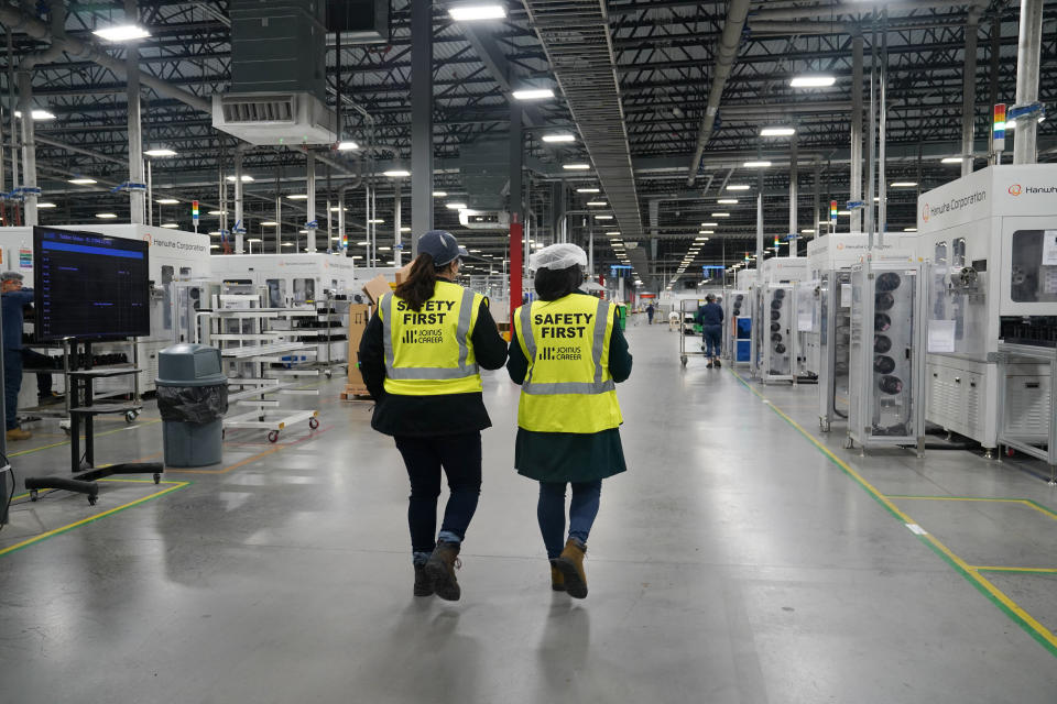 Employees work on solar panels at the QCells solar energy manufacturing factory in Dalton, Georgia, U.S., March 2, 2023. REUTERS/Megan Varner