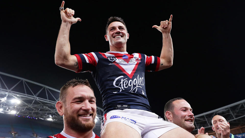 Cooper Cronk, pictured here after winning the 2019 NRL grand final with the Roosters. 