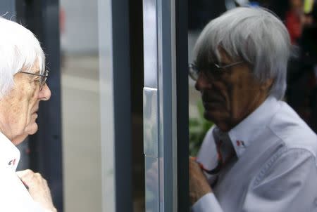 Formula One impresario Bernie Ecclestone is reflected in the window of his bus before the start of the Austrian F1 Grand Prix at the Red Bull Ring circuit in Spielberg, Austria, June 21, 2015. REUTERS/Leonhard Foeger