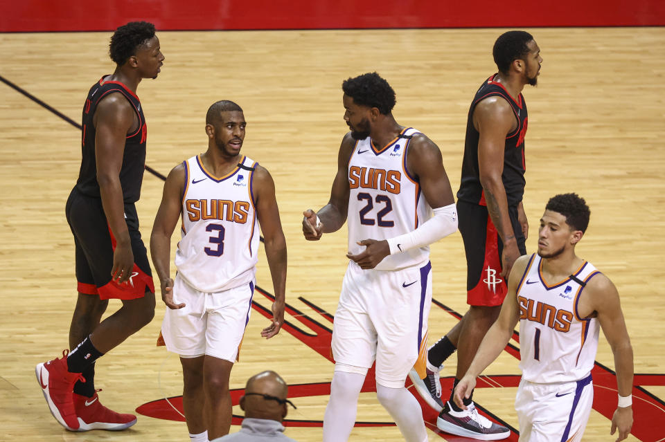 Phoenix Suns guard Chris Paul (3) and center Deandre Ayton (22) talk during a timeout during the fourth quarter against the Houston Rockets during an NBA basketball game in Houston, Monday, April 5, 2021. (Troy Taormina/Pool Photo via AP)