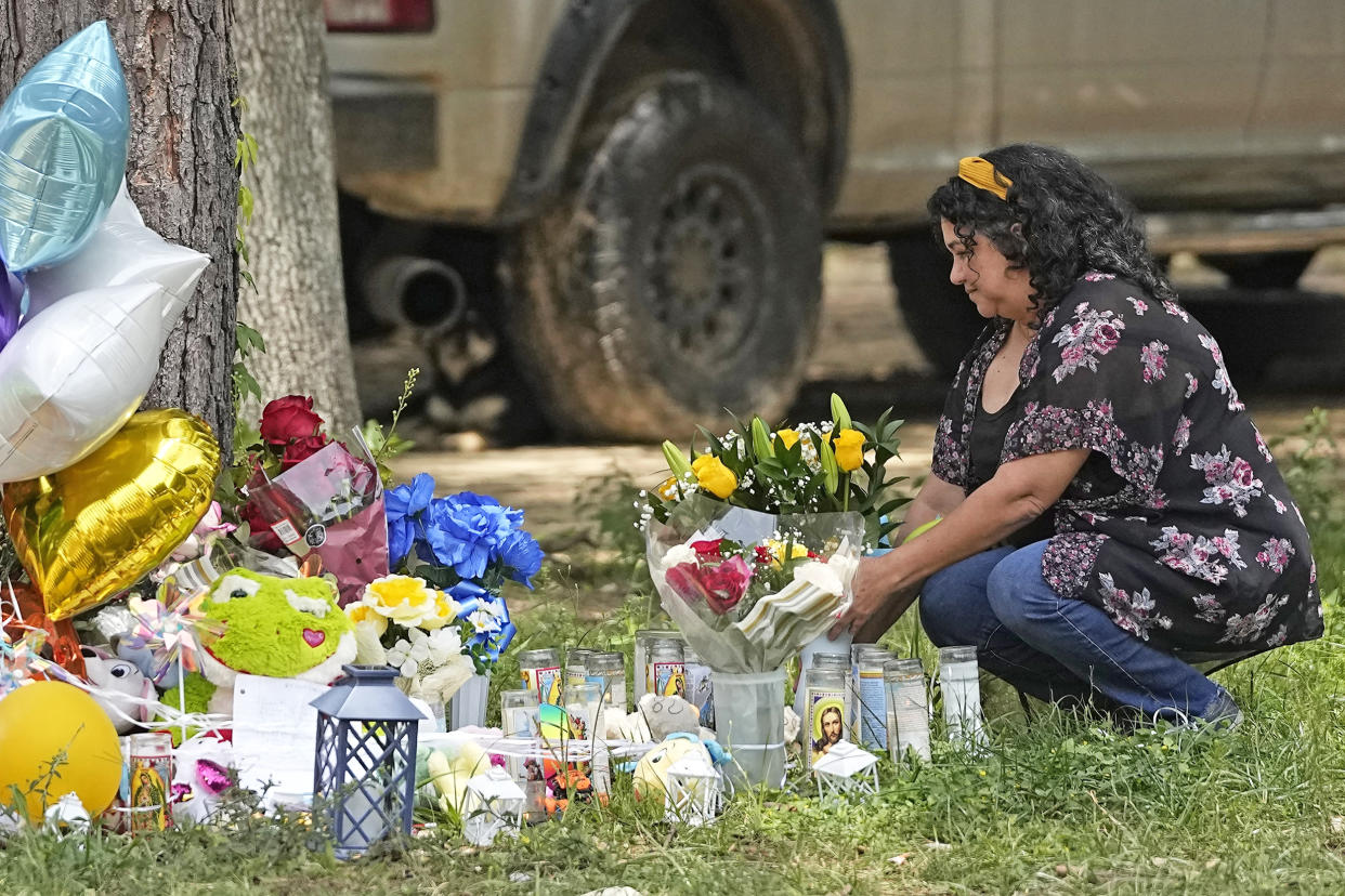Maria Rodriguez places flowers Tuesday, May 2, 2023, outside the home where a mass shooting occurred Friday, in Cleveland, Texas. The search for the suspected gunman who allegedly shot five of his neighbors, including a child, after they asked him to stop firing off rounds in his yard stretched into a fourth day Tuesday. (David J. Phillip / AP)
