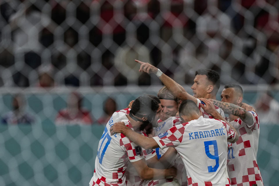 Croatia players celebrate after teammate Marko Livaja scored their side's second goal during the World Cup group F soccer match between Croatia and Canada, at the Khalifa International Stadium in Doha, Qatar, Sunday, Nov. 27, 2022. (AP Photo/Martin Meissner)