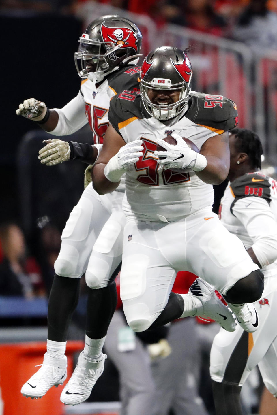 Tampa Bay Buccaneers linebacker Sam Acho, left, celebrates Tampa Bay Buccaneers defensive tackle Vita Vea's touchdown against the Atlanta Falcons during the first half of an NFL football game, Sunday, Nov. 24, 2019, in Atlanta. (AP Photo/John Bazemore)