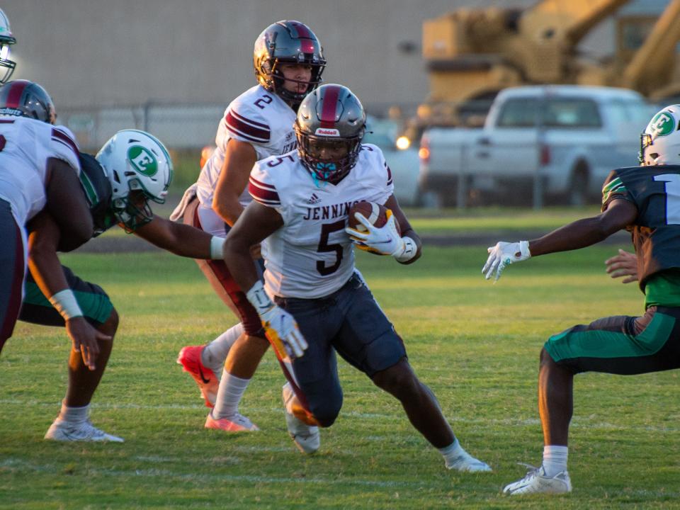 Trevor Etienne runs with the ball as the Jennings Bulldogs take on Eunice Friday, September 10, 2021.