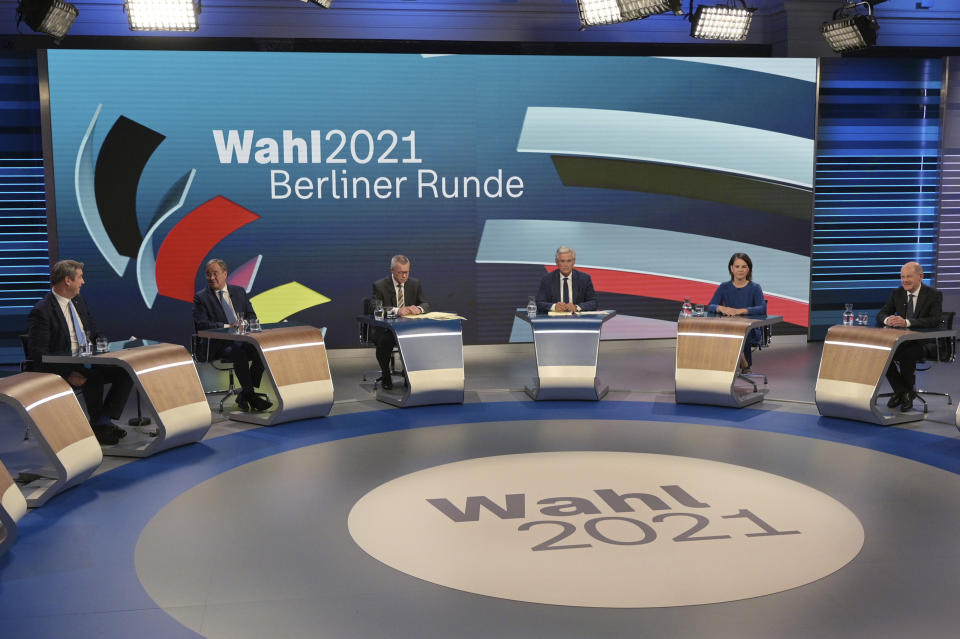 From left: CSU leader Markus Soeder, Armin Laschet of the CDU, the CDU/CSU's candidate for chancellor, moderators Rainald Becker and Peter Frey, Annalena Baerbock, candidate for chancellor of the Green Party, Olaf Scholz, candidate for chancellor of the SPD, prepare to talk about the Bundestag election in an election studio of ZDF at the "Berliner Runde" Sunday Sept. 2021 in Berlin. Projections show Germany’s center-left Social Democrats locked in a very close race with outgoing German Chancellor Angela Merkel’s center-right bloc, which is heading toward its worst-ever result in the country’s parliamentary election. (Sebastian Gollnow/Pool via AP)
