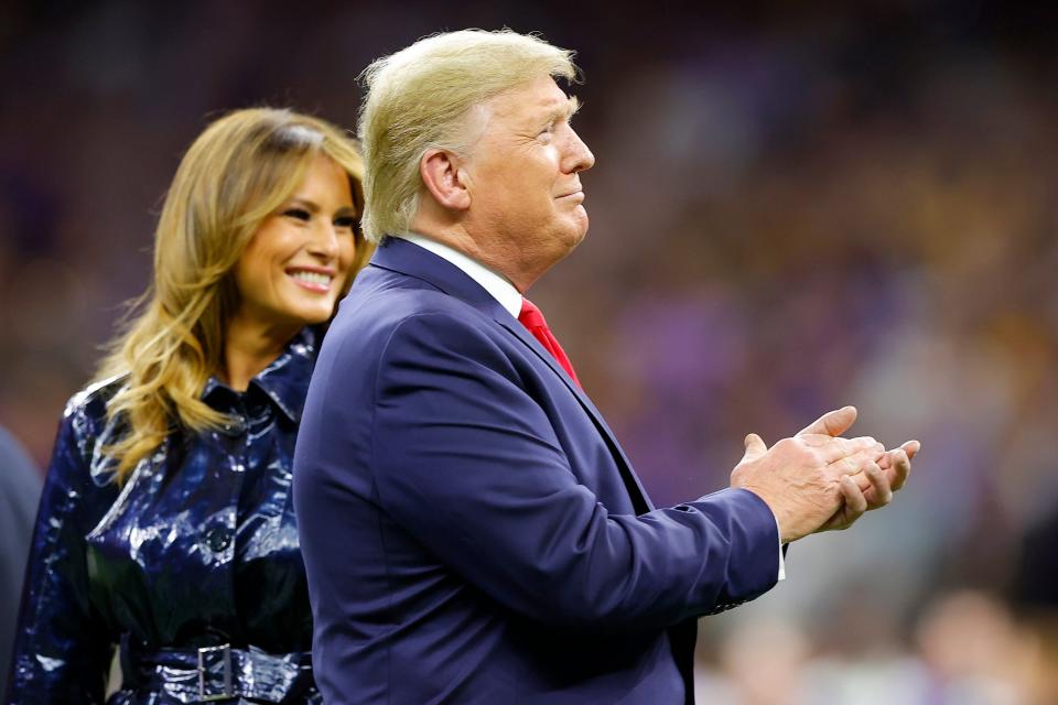 The First Lady and US President Donald Trump walk on to the pitch before the game (Getty Images)