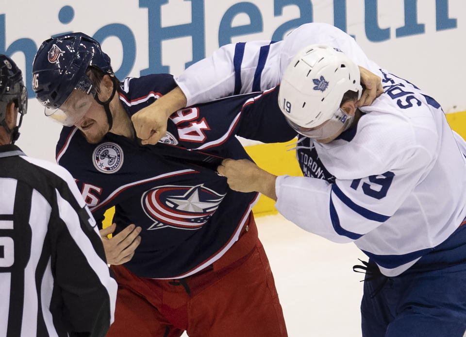 Toronto Maple Leafs center Jason Spezza (19) lands a punch on Columbus Blue Jackets defenseman Dean Kukan (46) during the second period of an NHL hockey playoff game Friday, Aug. 7, 2020, in Toronto. (Frank Gunn/The Canadian Press via AP)