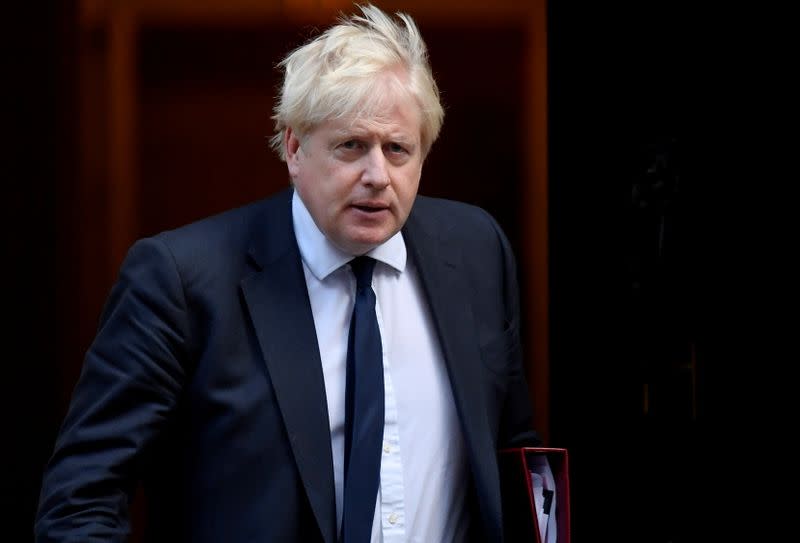 Britain's PM Johnson walks outside Downing Street in London