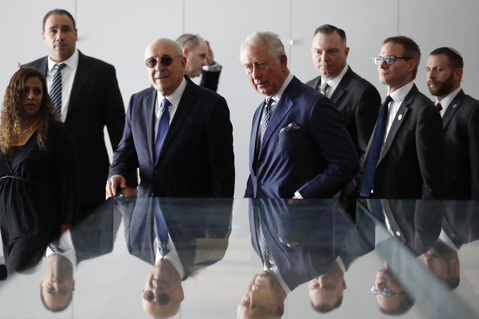 Britain's Prince Charles, center right, and the Chairman of the Board of Directors of the Israel Museum Isaac Molho, center left, arrive prior to a reception for Holocaust survivors at the Israel Museum in Jerusalem, Thursday, Jan. 23, 2020. (AP Photo/Frank Augstein, Pool)