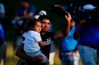 <p>Jason Day of Australia walks off the 18th green with his son Dash after winning the 2015 PGA Championship with a score of 20-under par at Whistling Straits on August 16, 2015 in Sheboygan, Wisconsin. (Photo by Kevin C. Cox/Getty Images) </p>