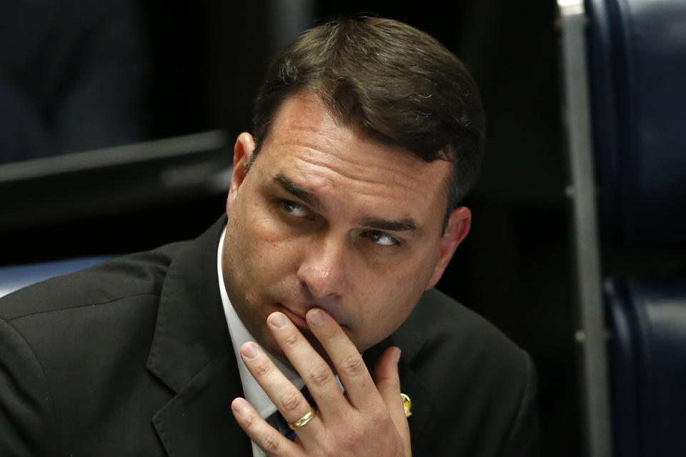 FILE - In this Oct. 22, 2019 file photo, Brazilian Senator Flavio Bolsonaro, son of the nation's president, attends the final voting session on pension reform at the Senate in Brasilia, Brazil. Sen. Bolsonaro, on Thursday, Dec. 19, 2019, accused "ill-intentioned" prosecutors of persecuting his family, one day after they searched a chocolate shop he co-owns as part of an investigation into allegedly suspicious financial movements. (AP Photo/Eraldo Peres, File)