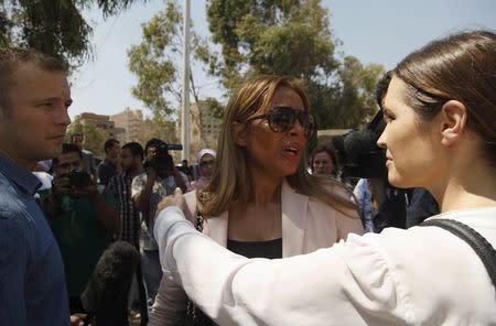 Marwa Omara, wife of Al Jazeera television journalist Mohamed Fahmy, reacts as she talks to a journalist outside a court in Cairo, Egypt, August 29, 2015. REUTERS/Asmaa Waguih