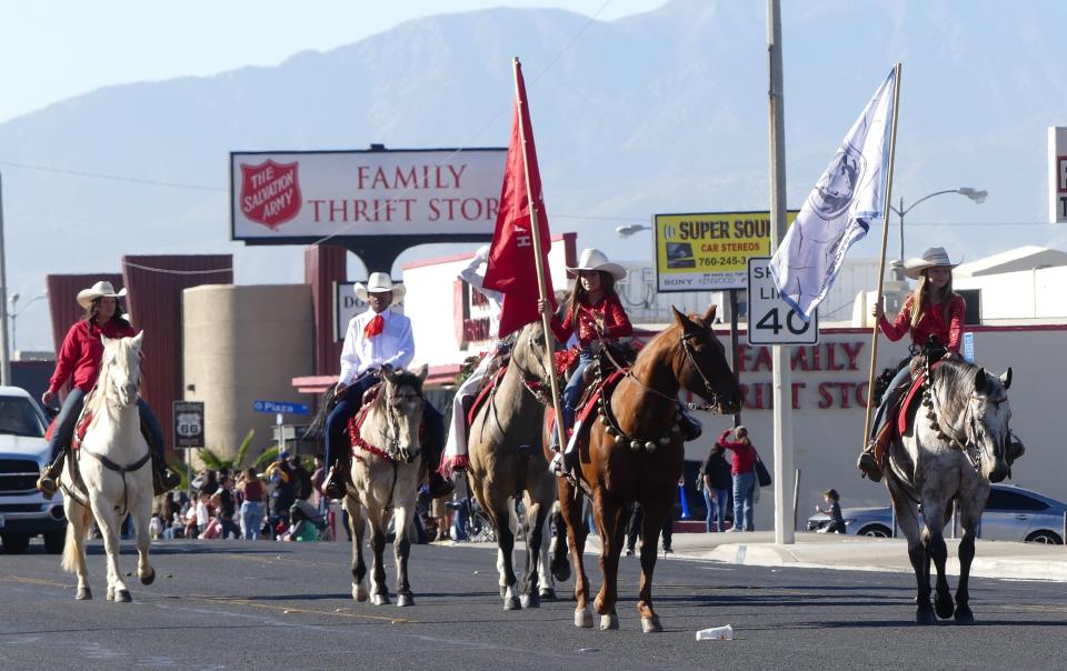 A group of Hesperia Wranglers make their way down Seventh Street on Saturday during the 74th Annual Victorville Christmas Parade.