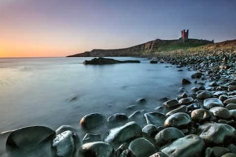 Dunstanburgh Castle Ruins looming in the distance - Credit: istock