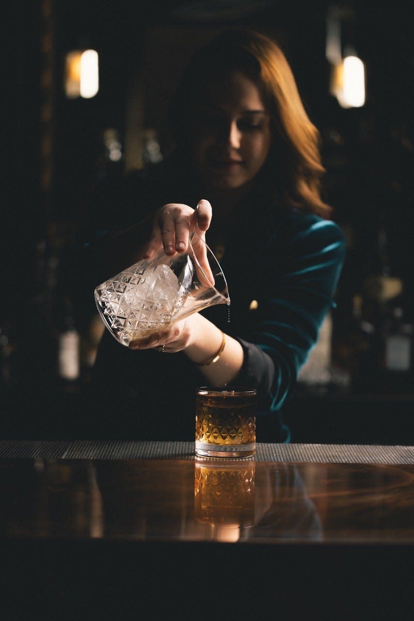 A bartender makes a cocktail at Highball.