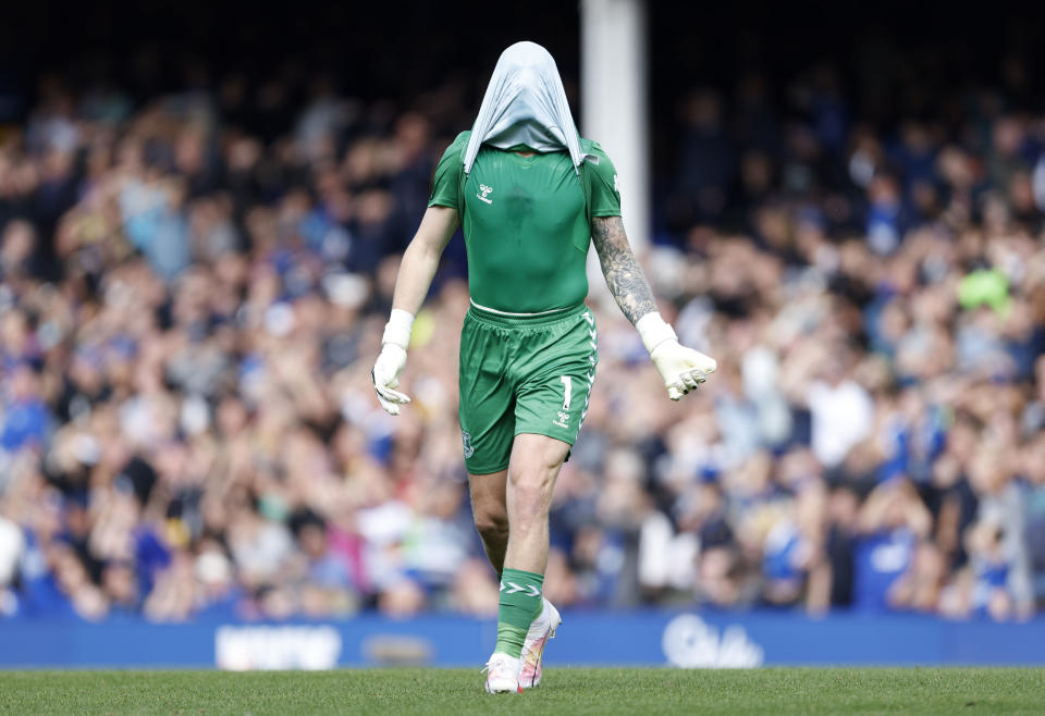 Everton goalkeeper Jordan Pickford pulls his jersey over his head in frustration during the Premier League soccer match between Everton and Fulham at Goodison Park, Liverpool, England, Saturday Aug. 12, 2023. (Richard Sellers/PA via AP)